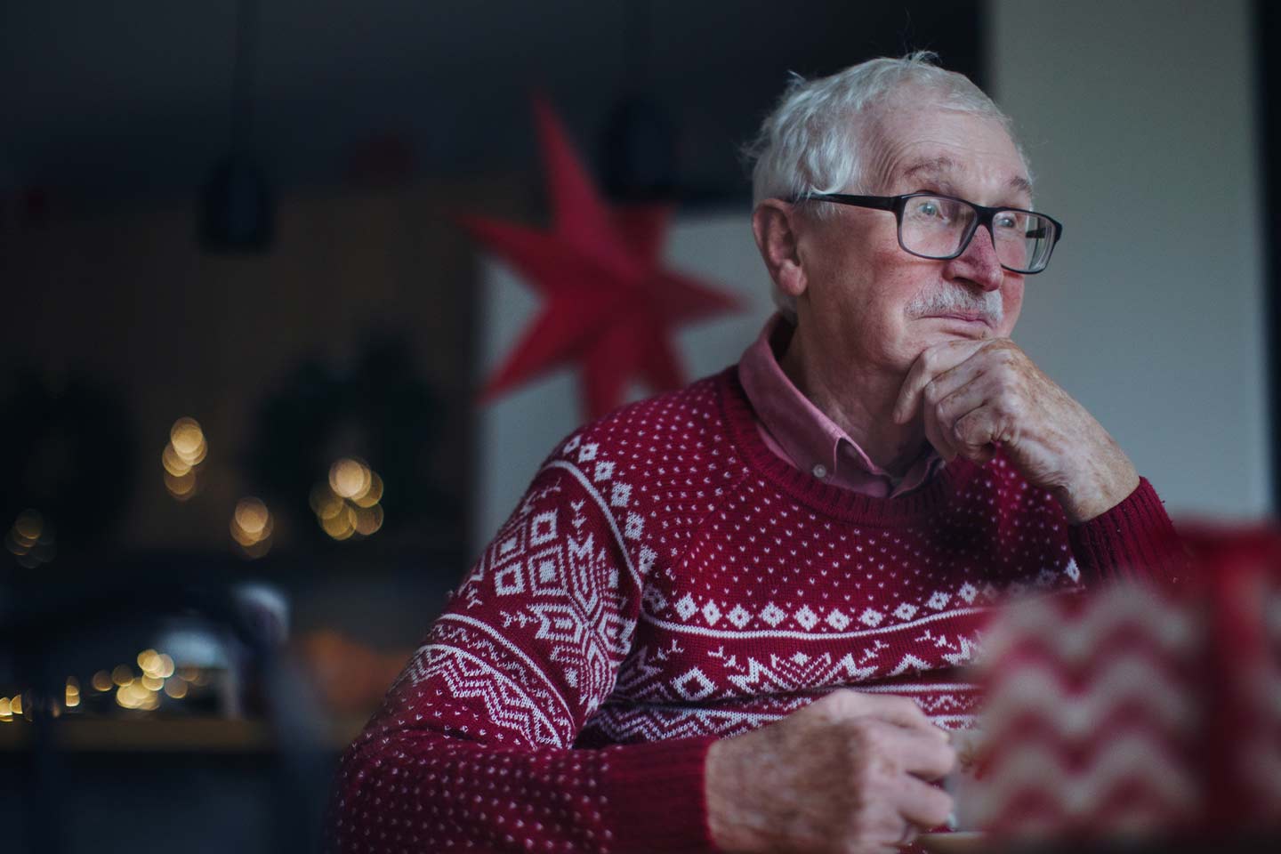 Photo of a man wearing a red and white christmas jumper