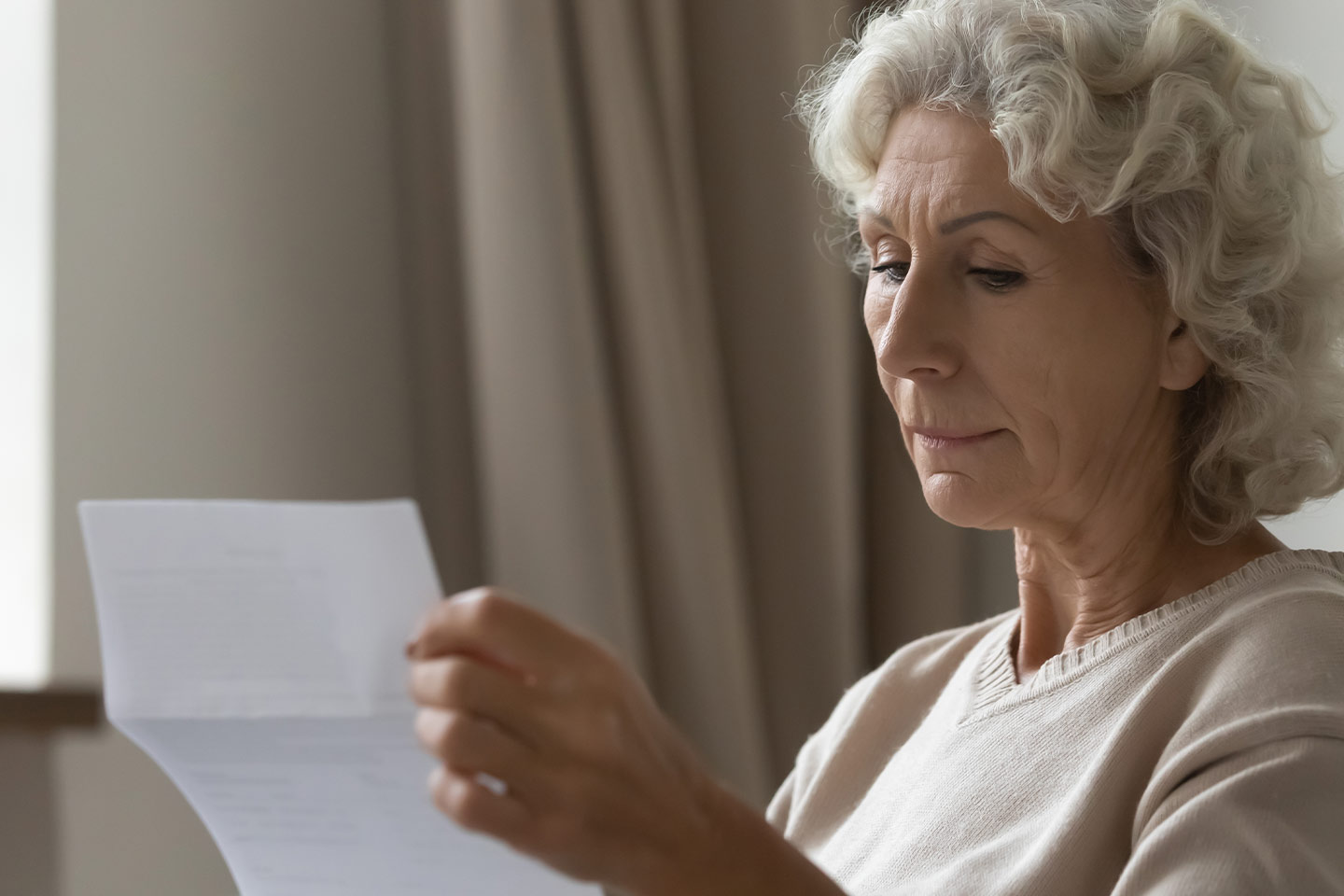 Photo of woman reading a letter