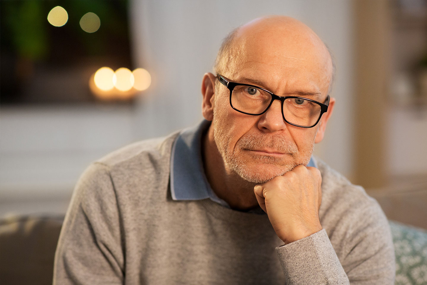 Photo of a man resting his chin on his hand