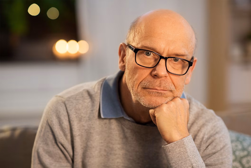 Photo of a man resting his chin on his hand