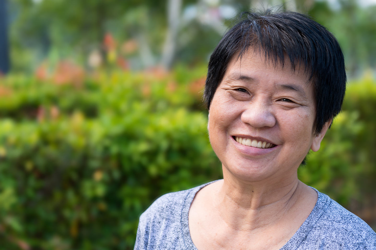 Photo of a woman smiling in a garden