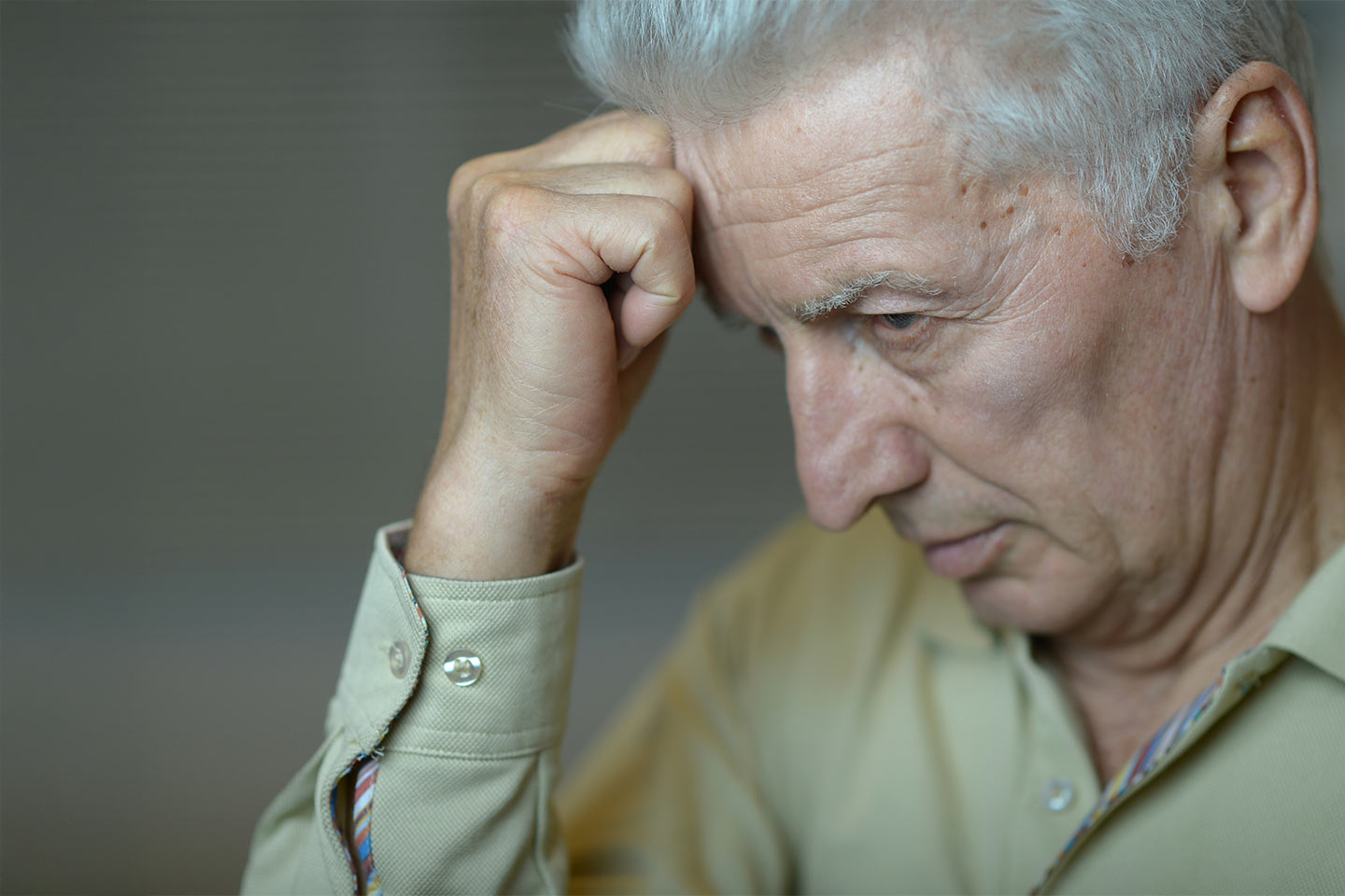Photo of a man resting his forehead on his fist