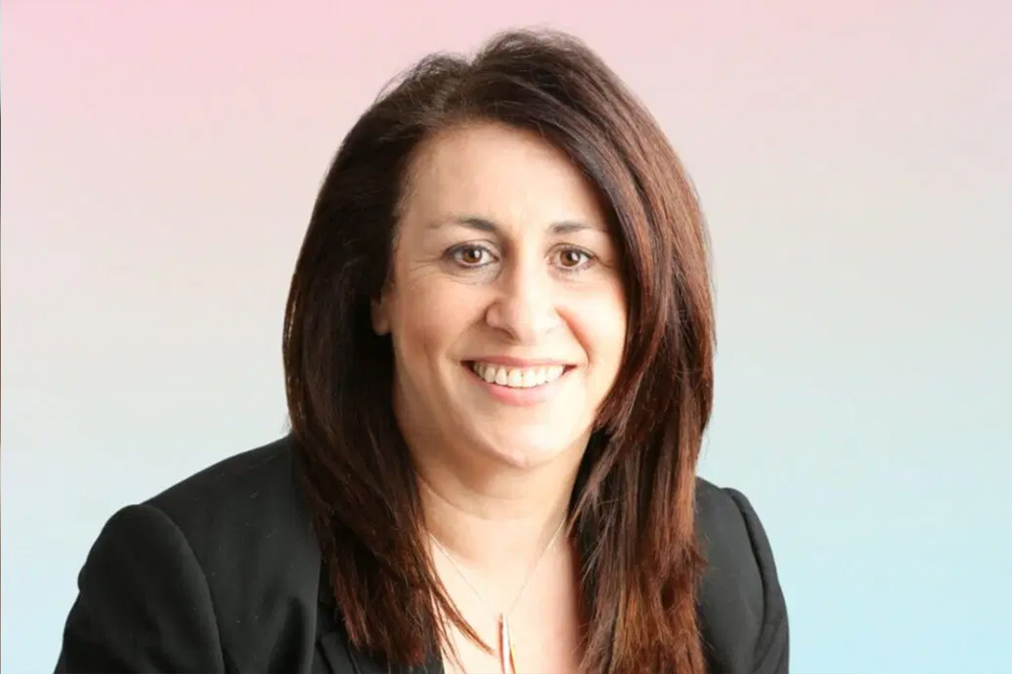 Photo of a woman wearing a suit jacket smiling