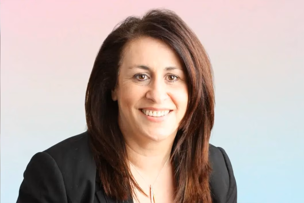 Photo of a woman wearing a suit jacket smiling