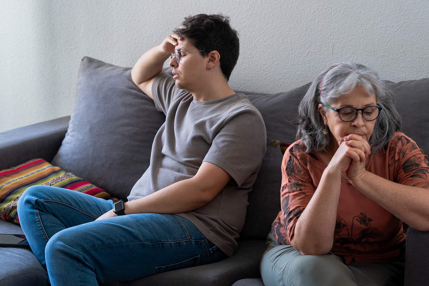 Photo of two people facing away from each other on a couch