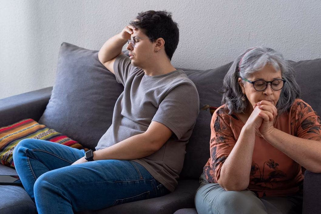 Photo of two people facing away from each other on a couch