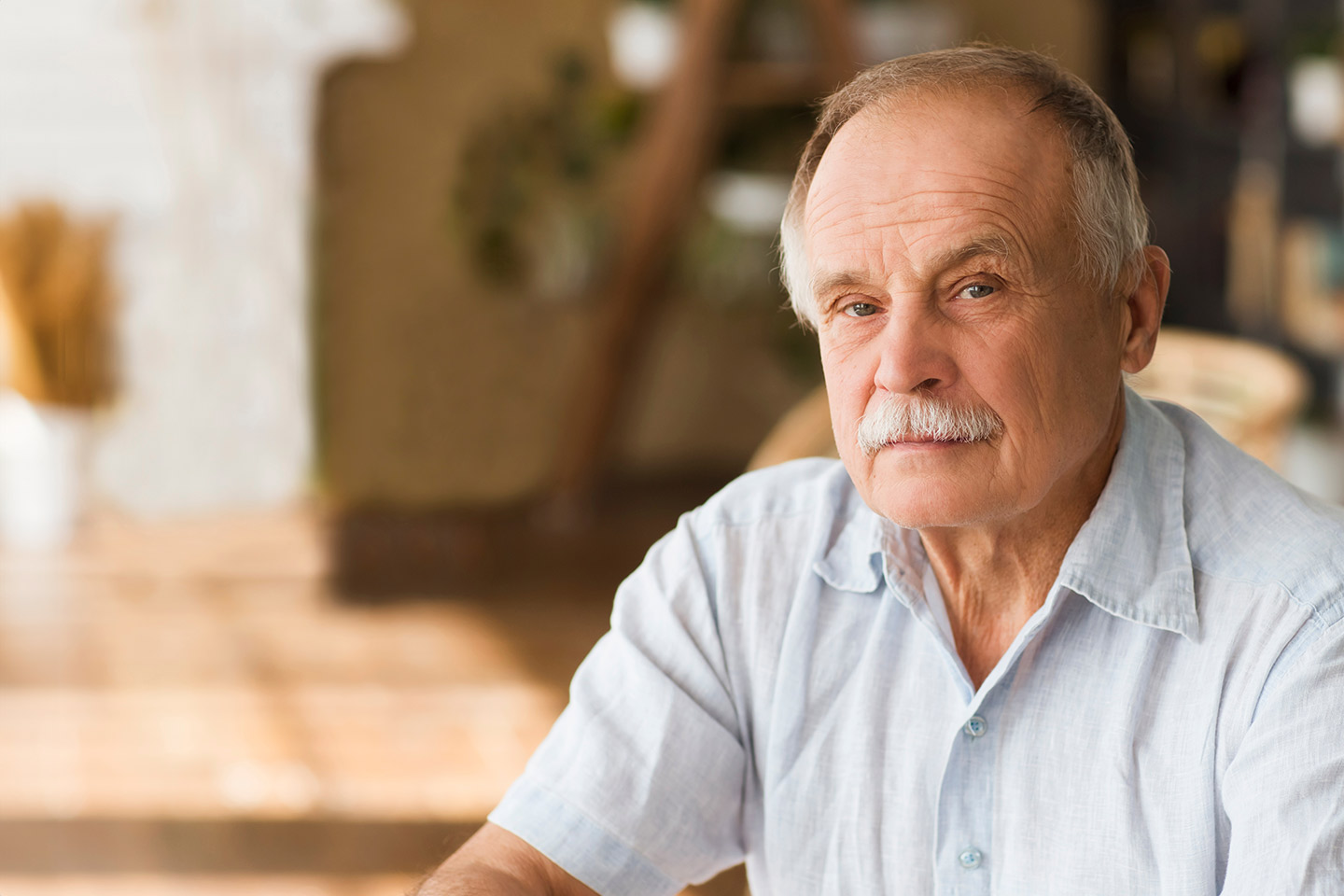 Image of an older caucasian man with a moustache