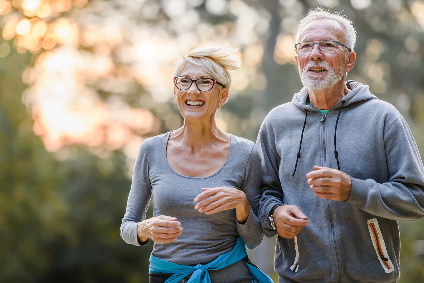 Photo of a couple in grey sweats jogging
