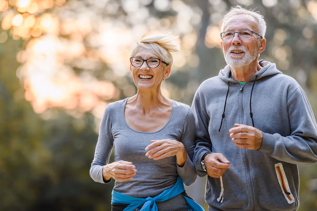Photo of a couple in grey sweats jogging