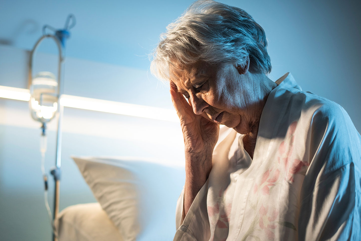 Photo of woman sitting on a hospital bed