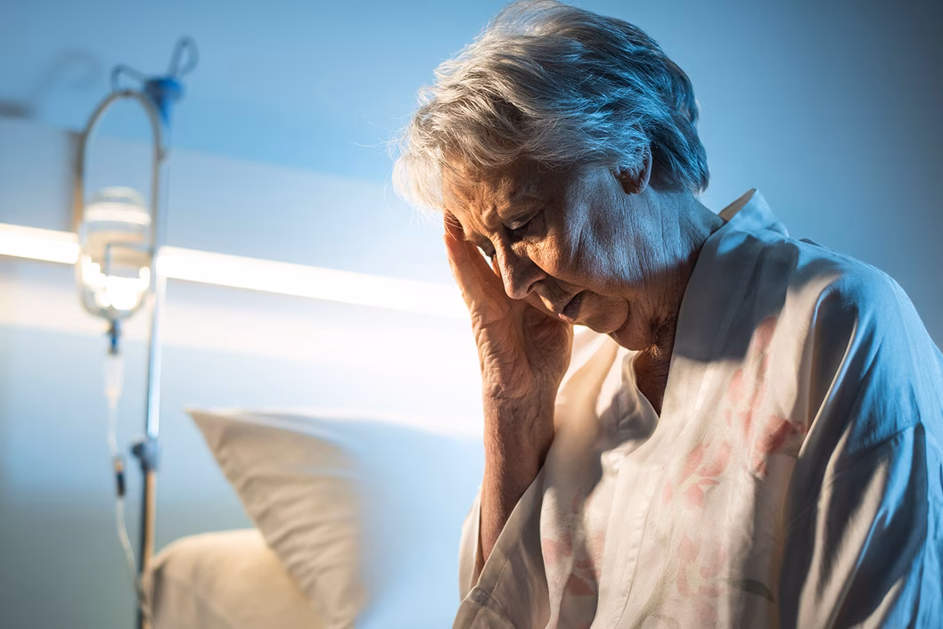 Photo of woman sitting on a hospital bed
