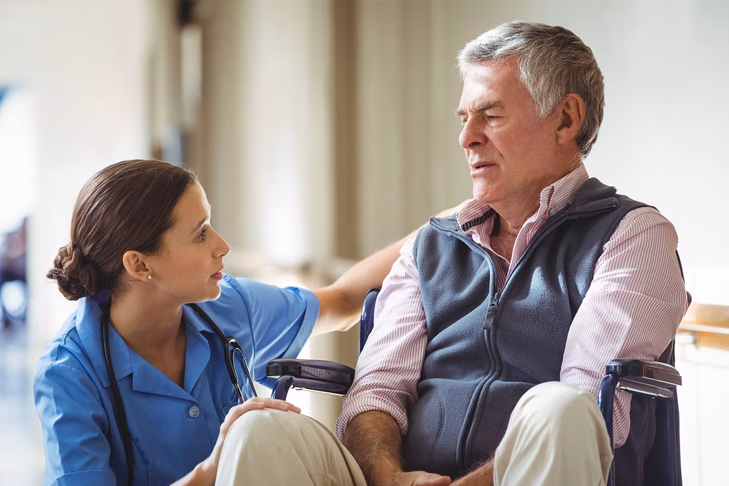 Photo of man in wheelchair and nurse