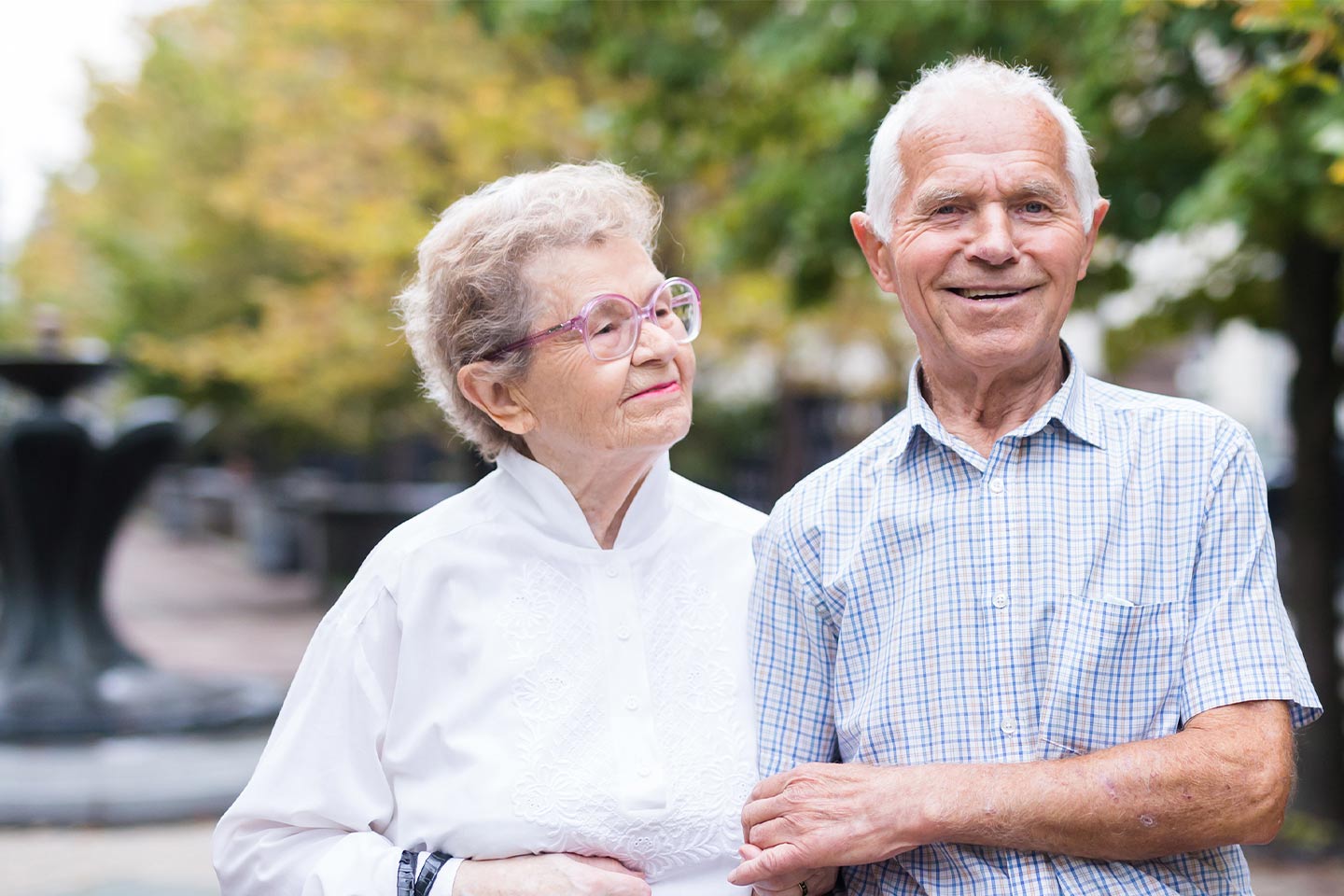 Photo of smiling couple with linked arms