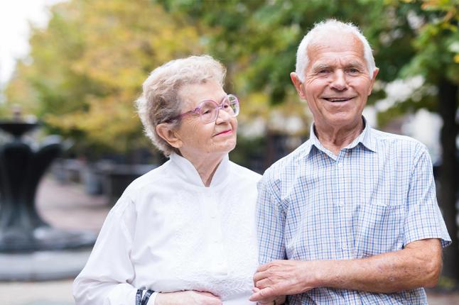 Photo of smiling couple with linked arms