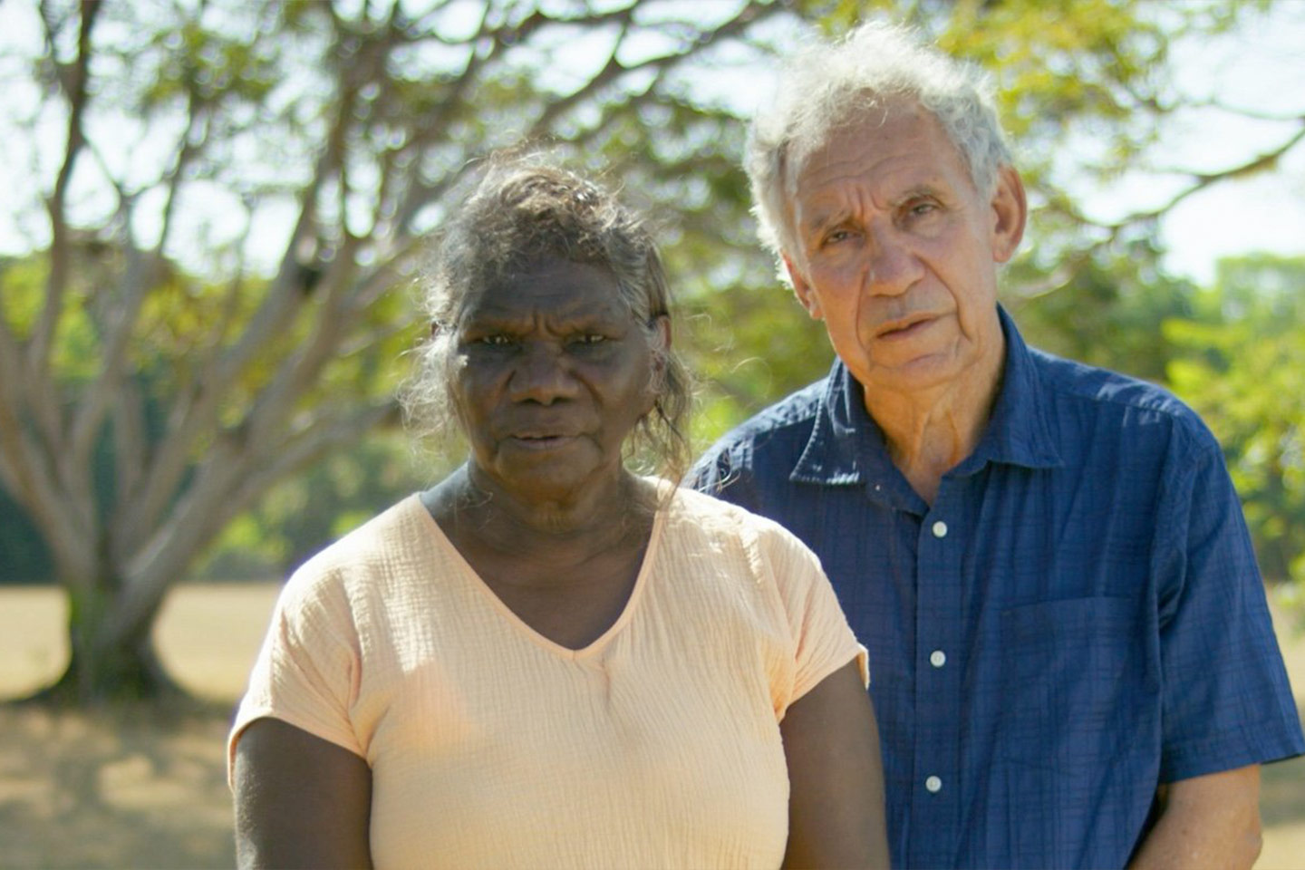 Photo of two people standing in a park