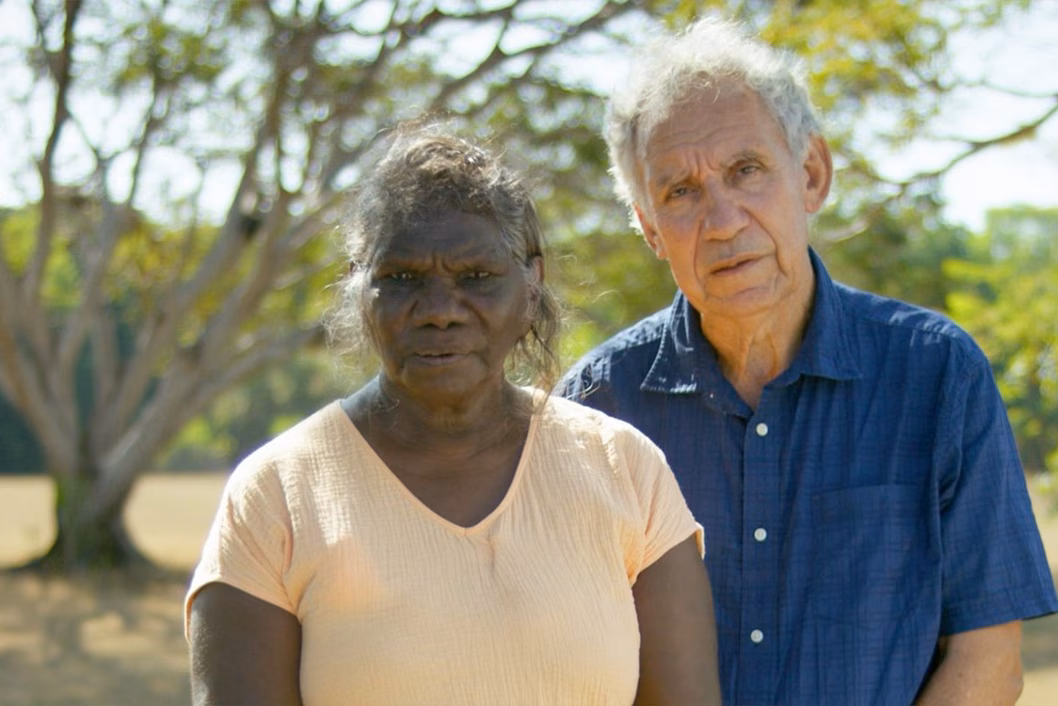 Photo of two people standing in a park