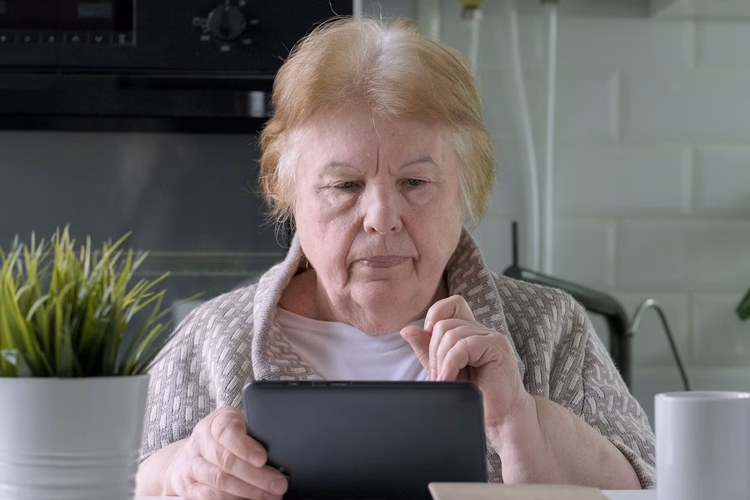 Image of an older woman looking at her IPad