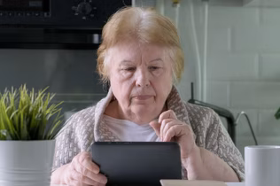 Image of an older woman looking at her IPad