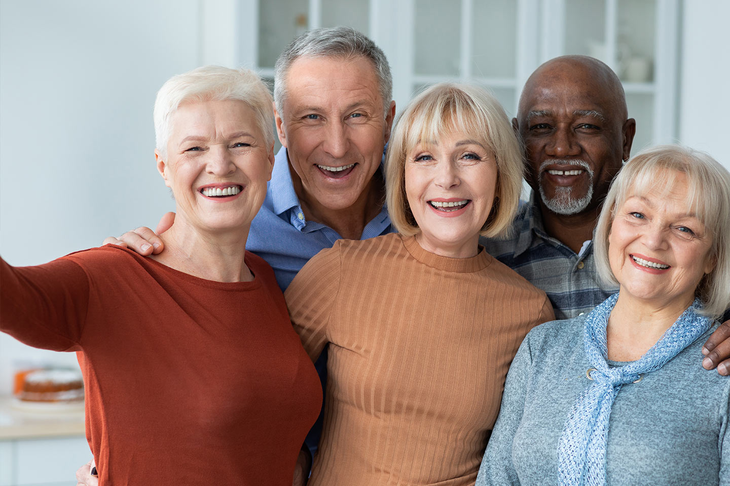 Group of people smiling as they take a selfie