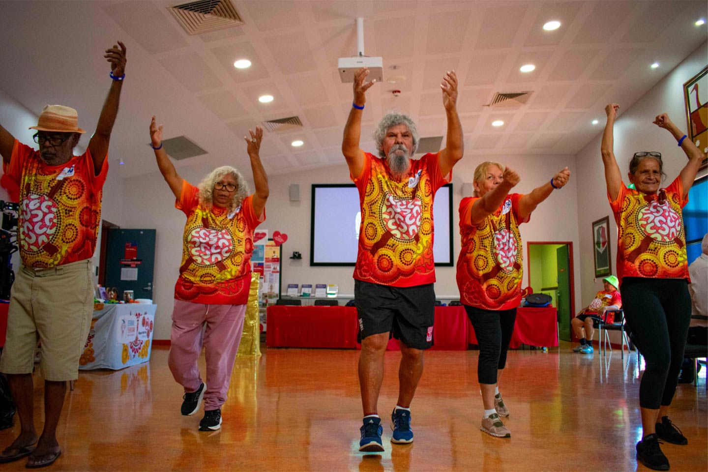 Photo of a fitness group wearing t-shirts featuring indigenous art