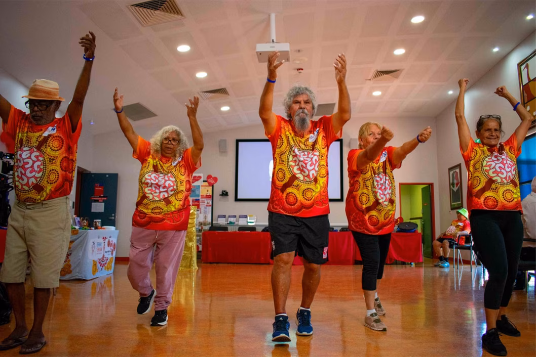 Photo of a fitness group wearing t-shirts featuring indigenous art