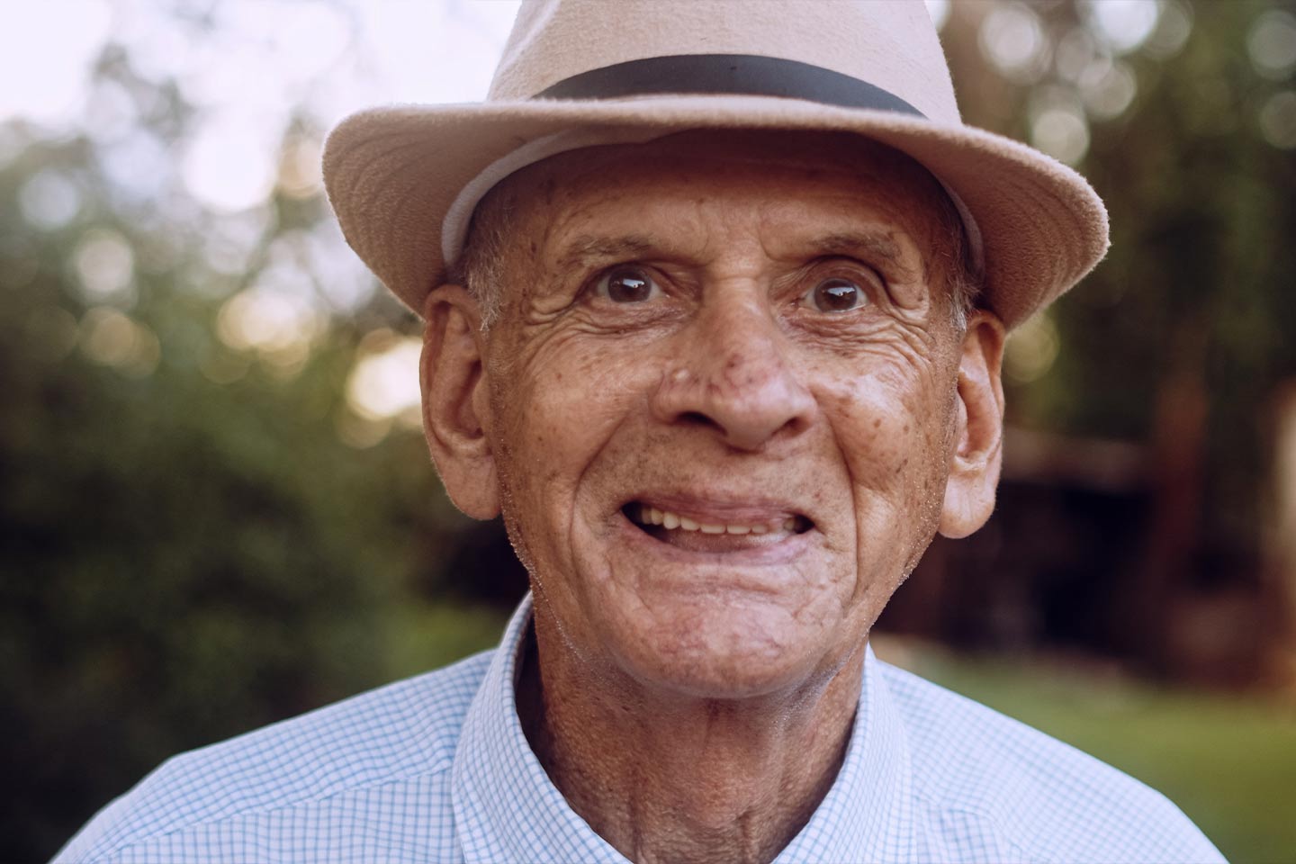 Photo of a smiling man wearing a hat