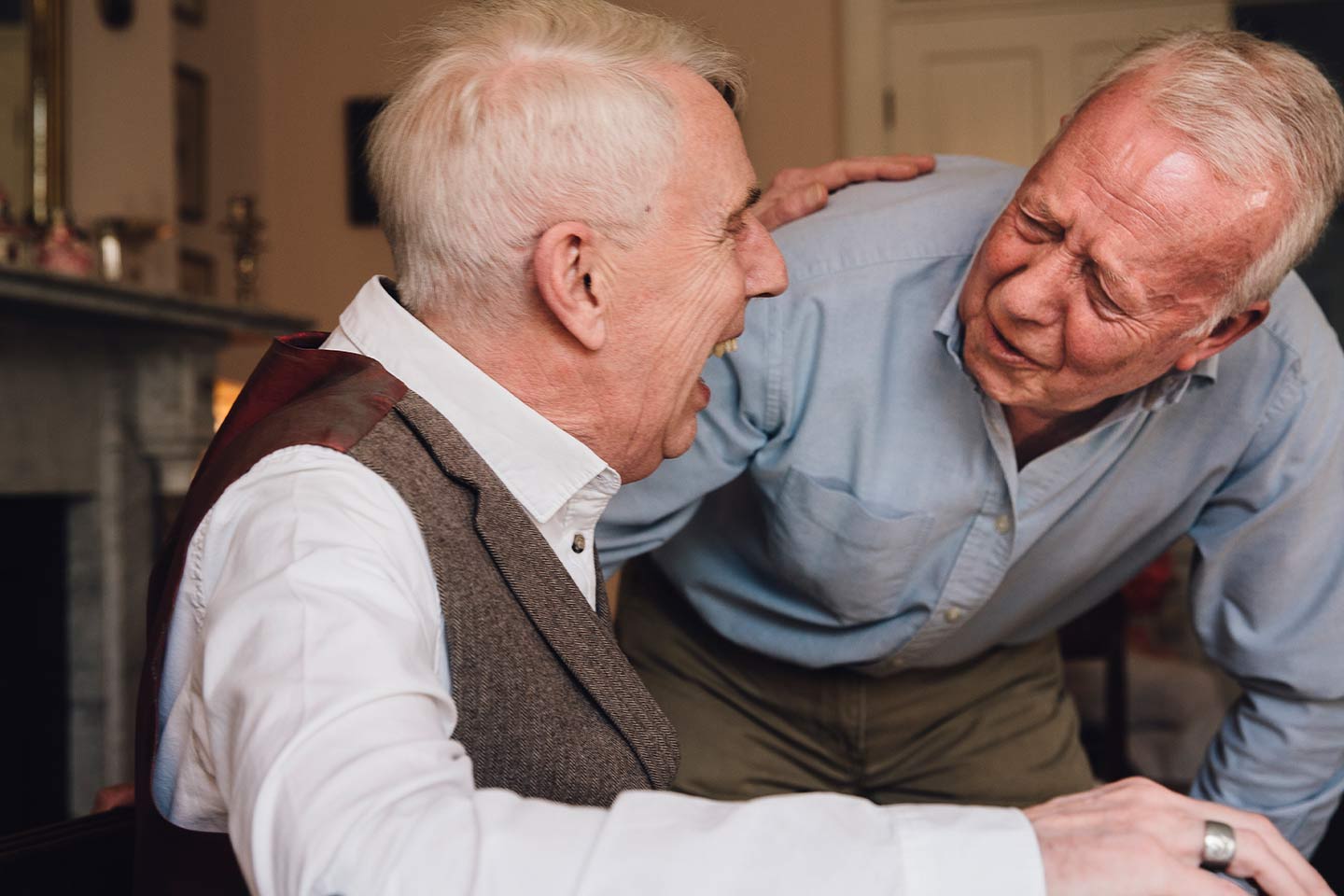 Photo of two older men having a laugh together