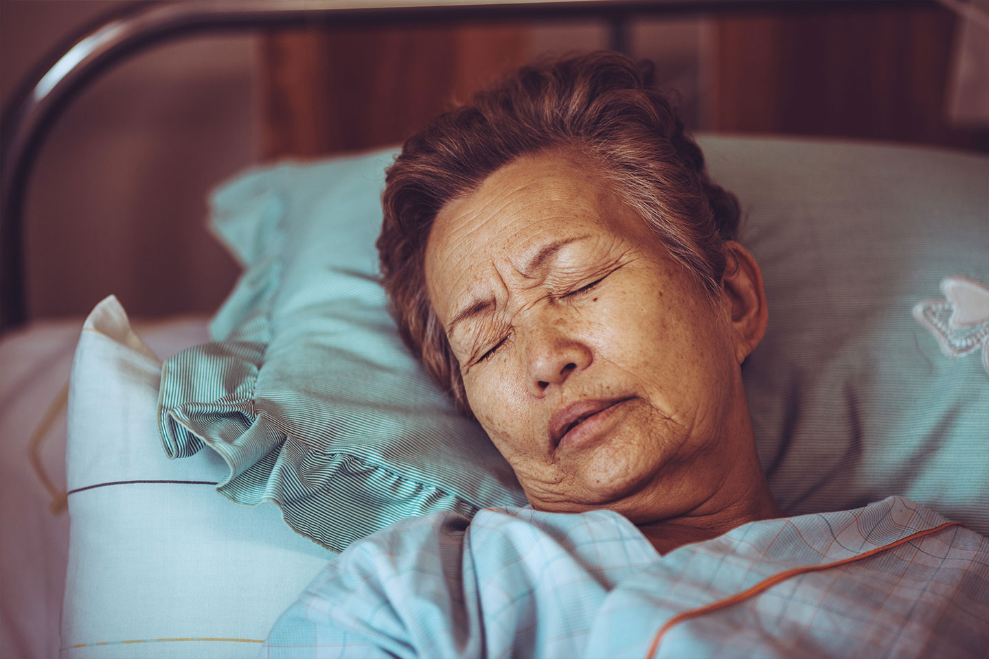 Photo of a woman asleep in a hospital bed