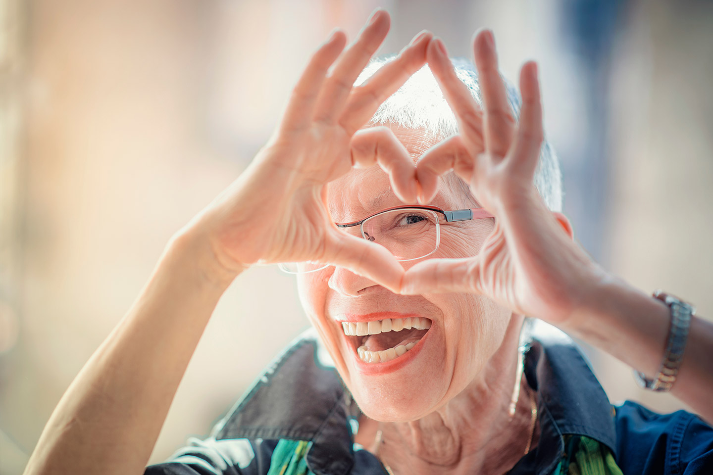 Photo of a woman making a heart shape with her hands