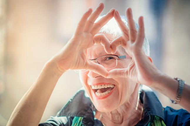 Photo of a woman making a heart shape with her hands