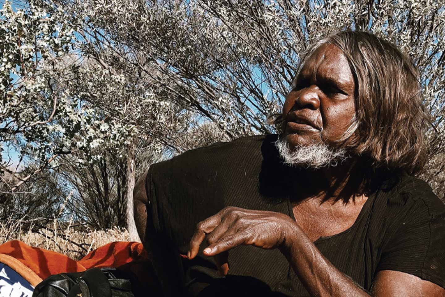 Photo of a woman sitting outdoors in the sun