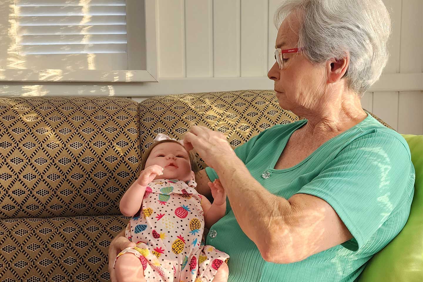 Photo of a woman with a baby doll