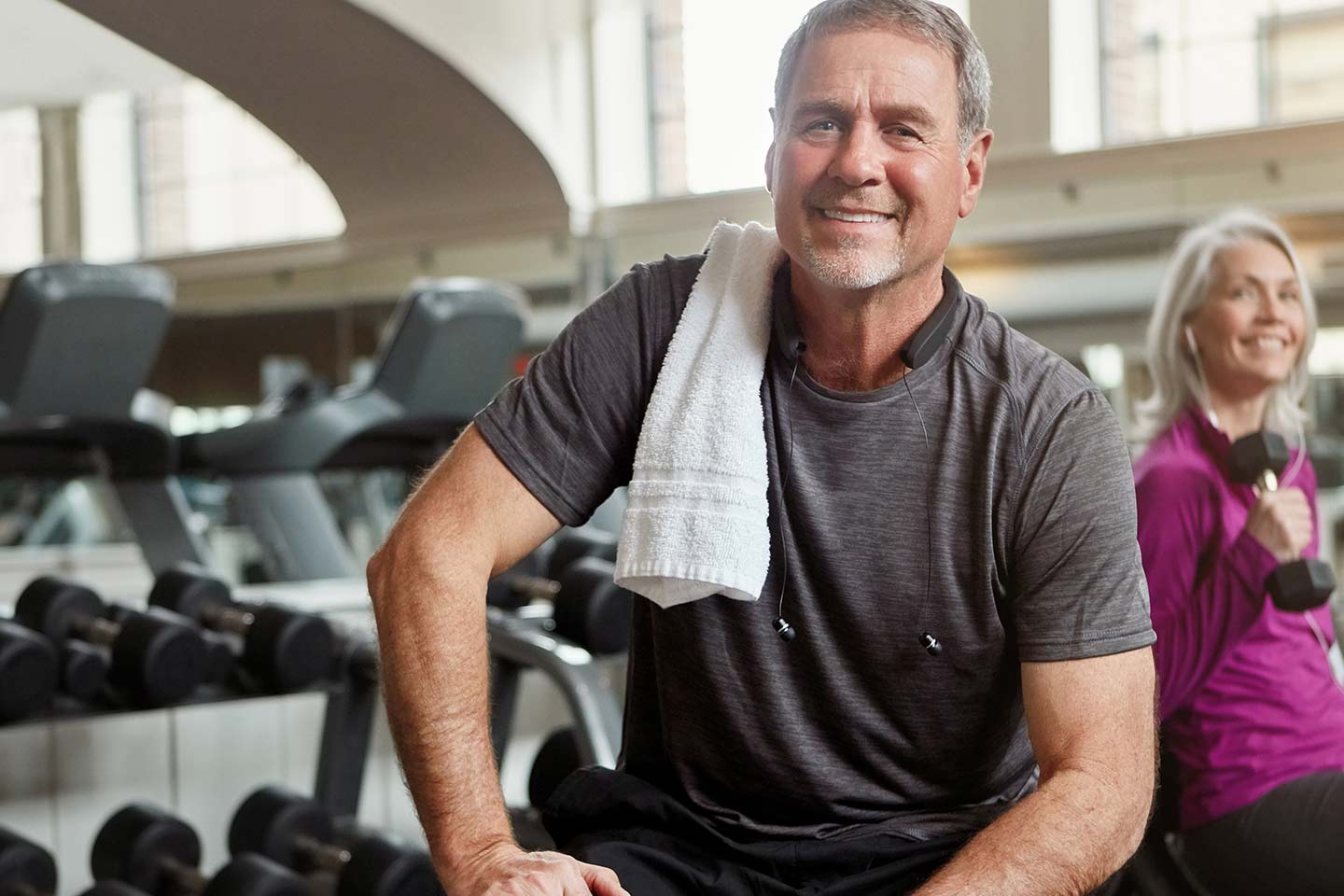 Photo of older couple in a gym with weights