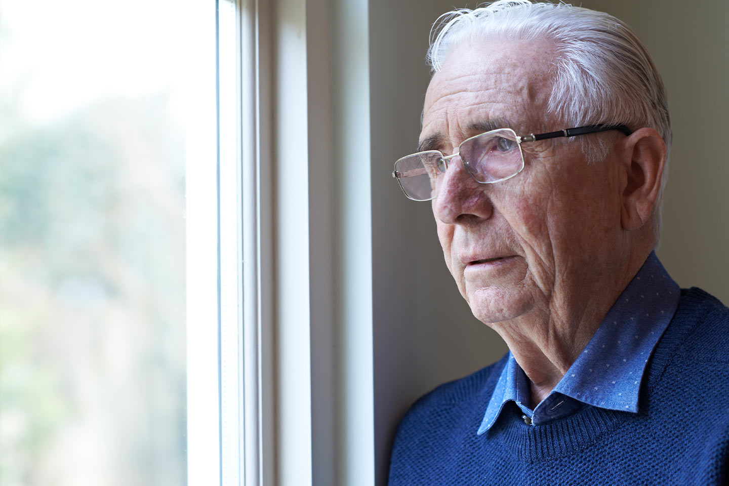 Photo of a man in glasses and a blue jumper