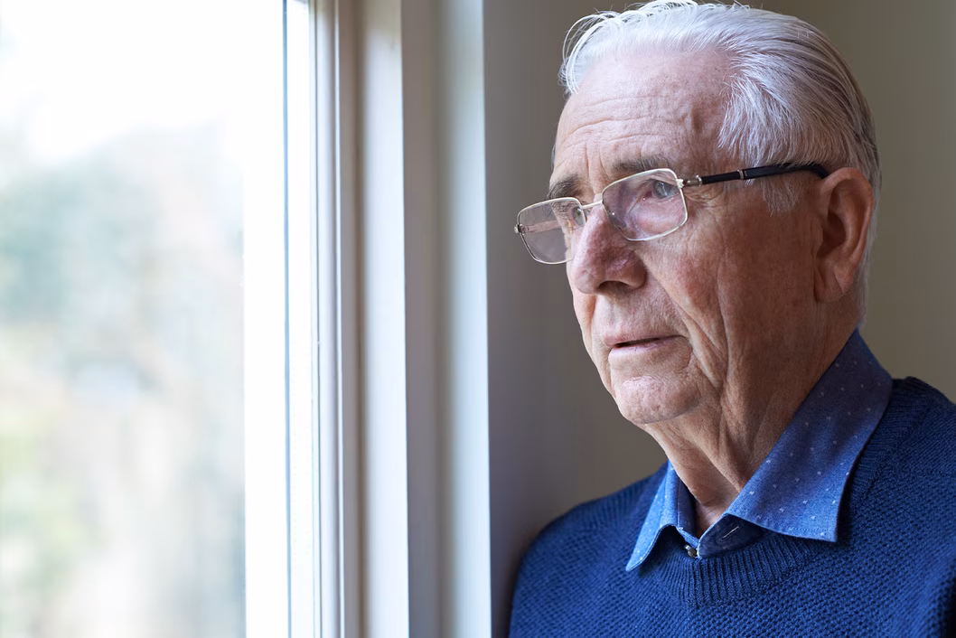 Photo of a man in glasses and a blue jumper