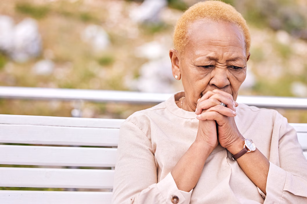 Photo of a woman sitting on a park bench