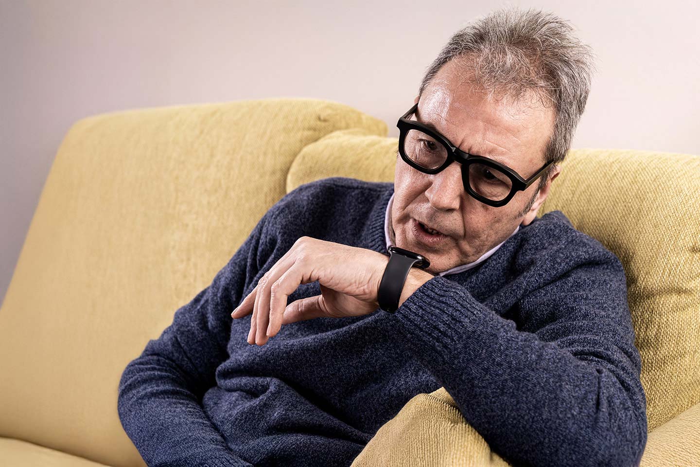 Photo of a man talking into his watch phone