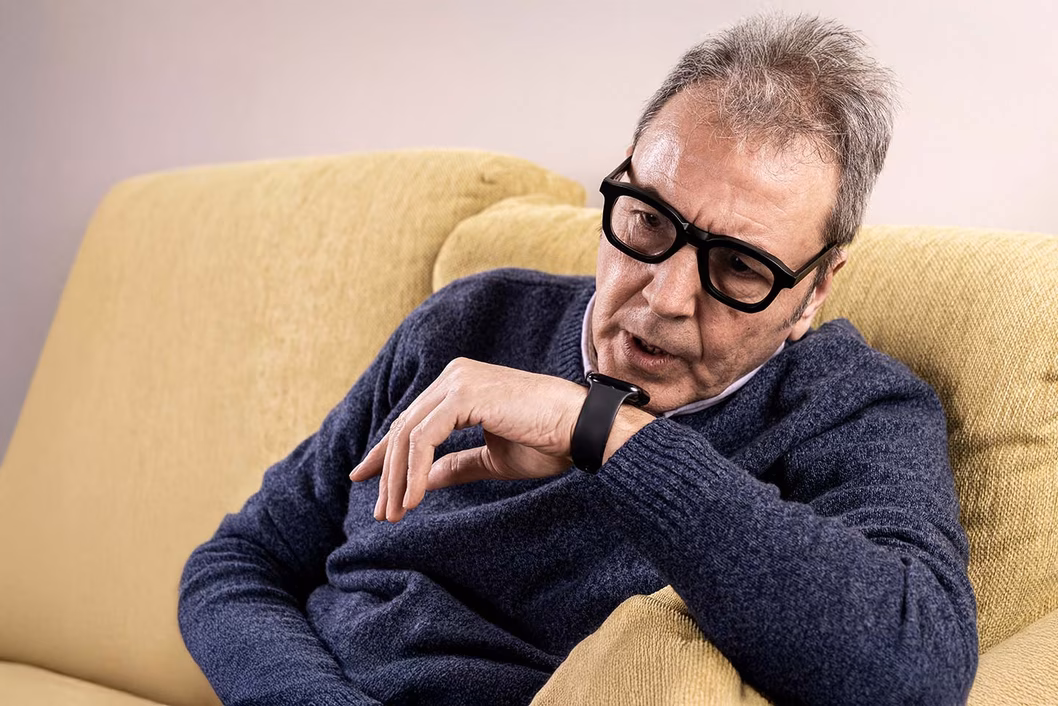 Photo of a man talking into his watch phone