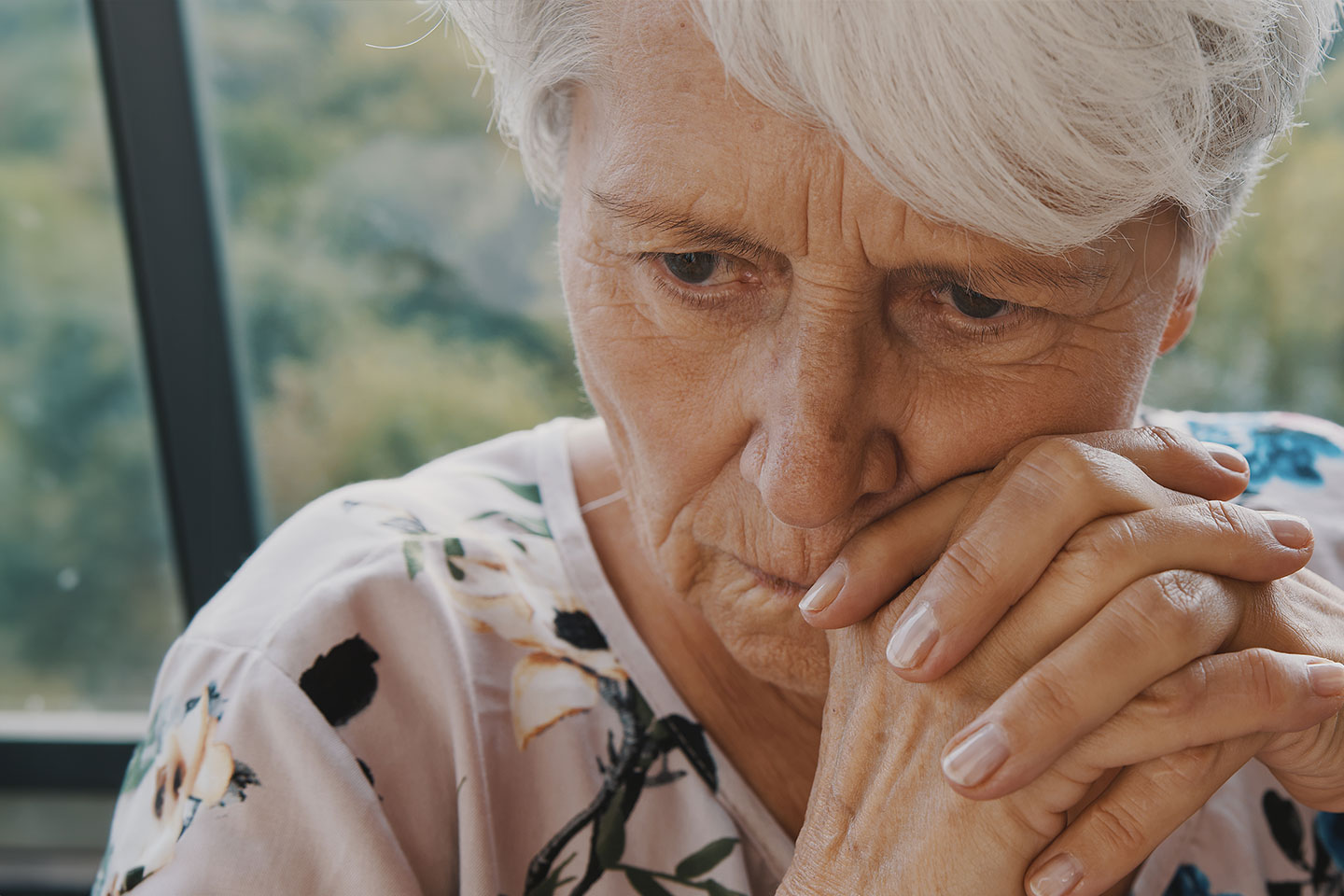 Photo of a woman in a floral top looking worried