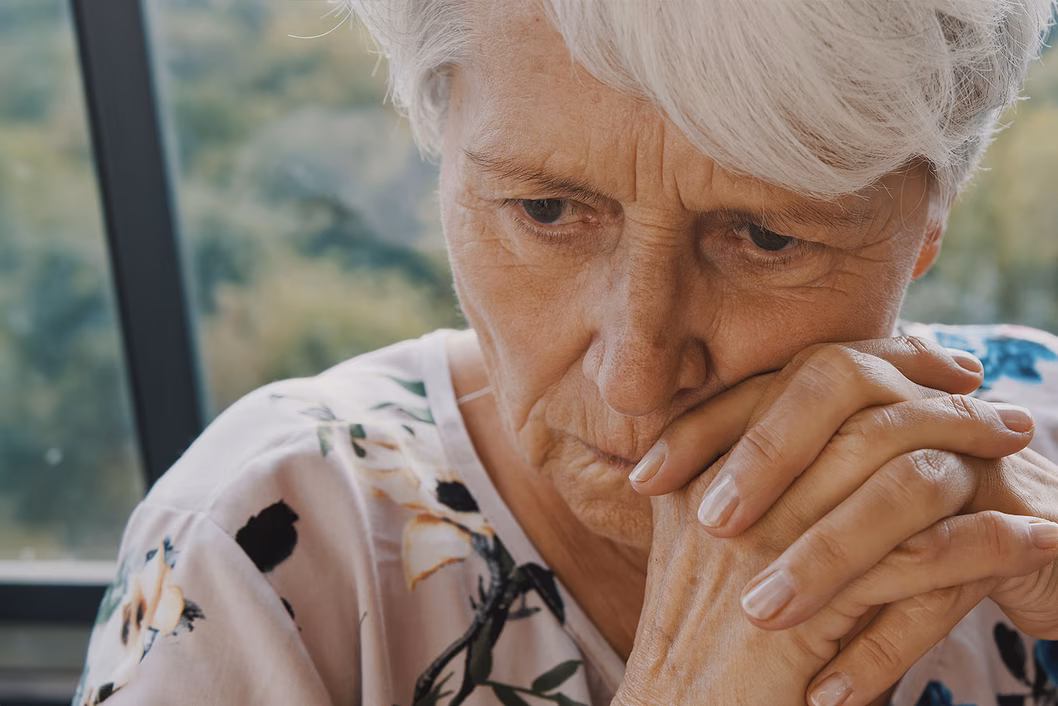 Photo of a woman in a floral top looking worried