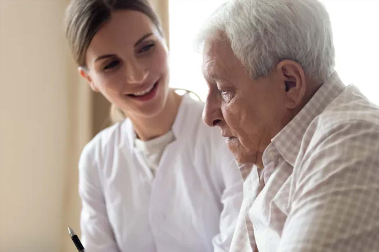 Photo of nurse attending to an older man
