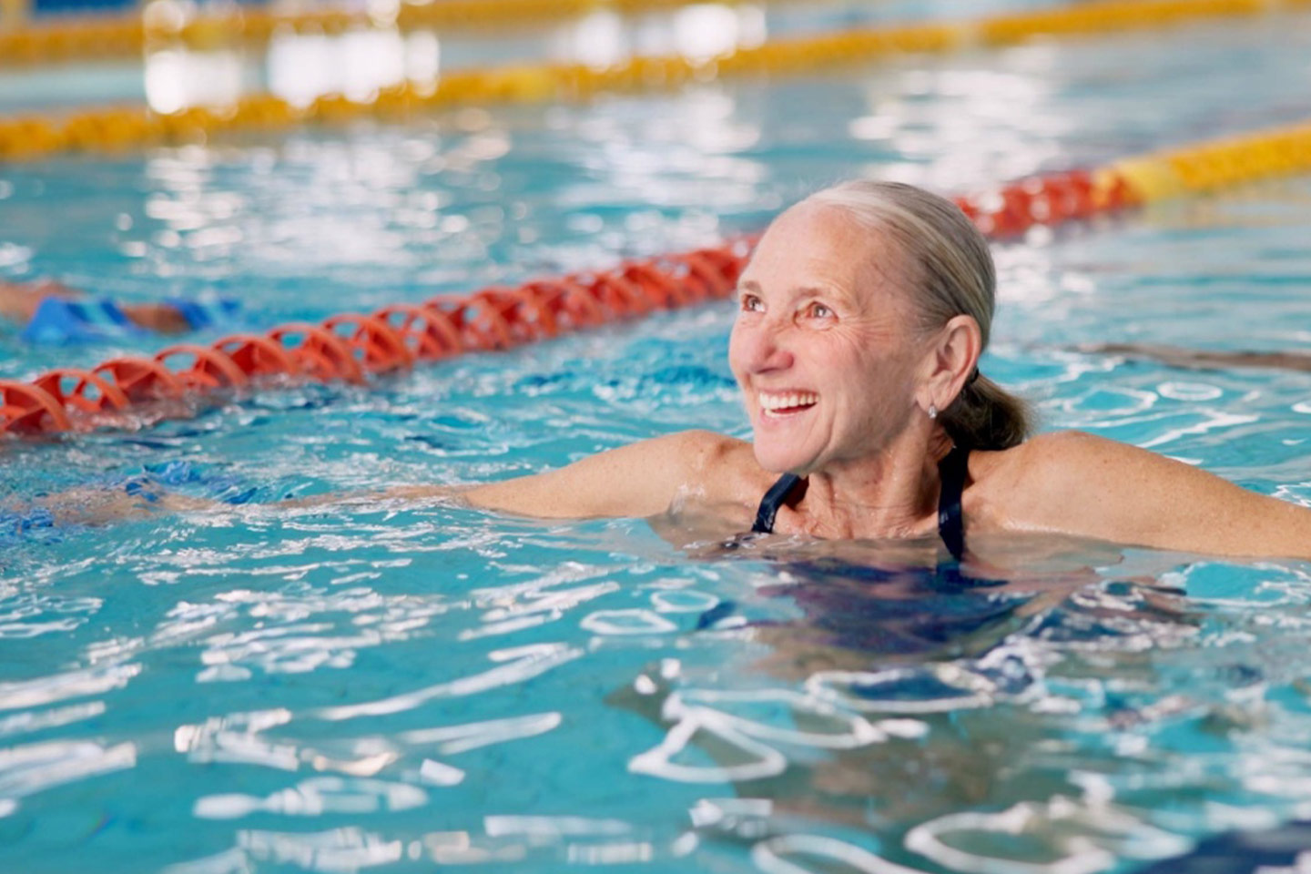 Photo of a smiling woman in a swimming pool
