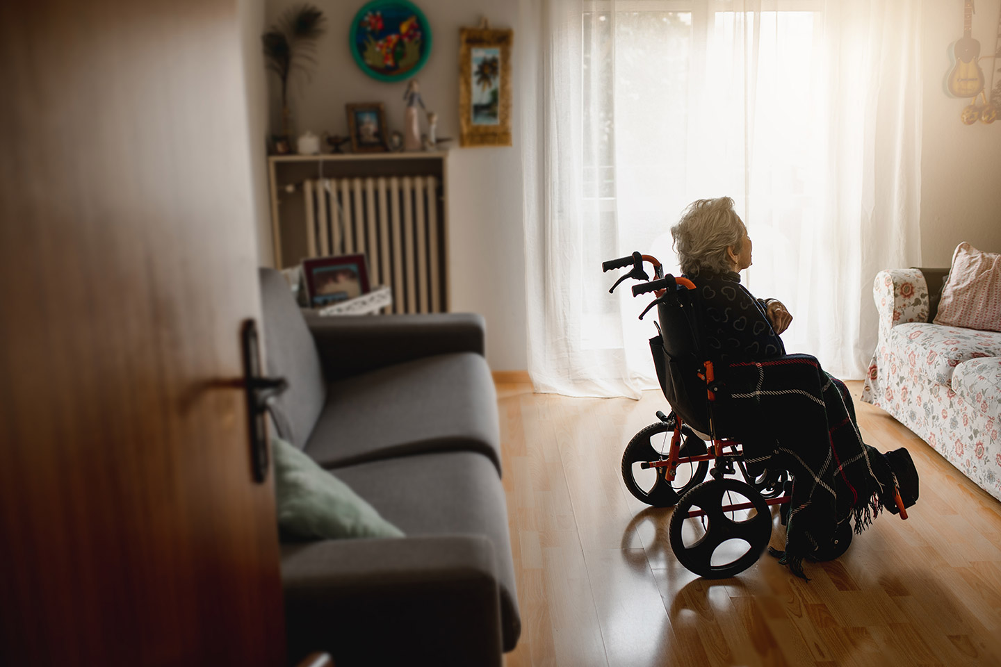 Photo of a woman in a room in a wheelchair
