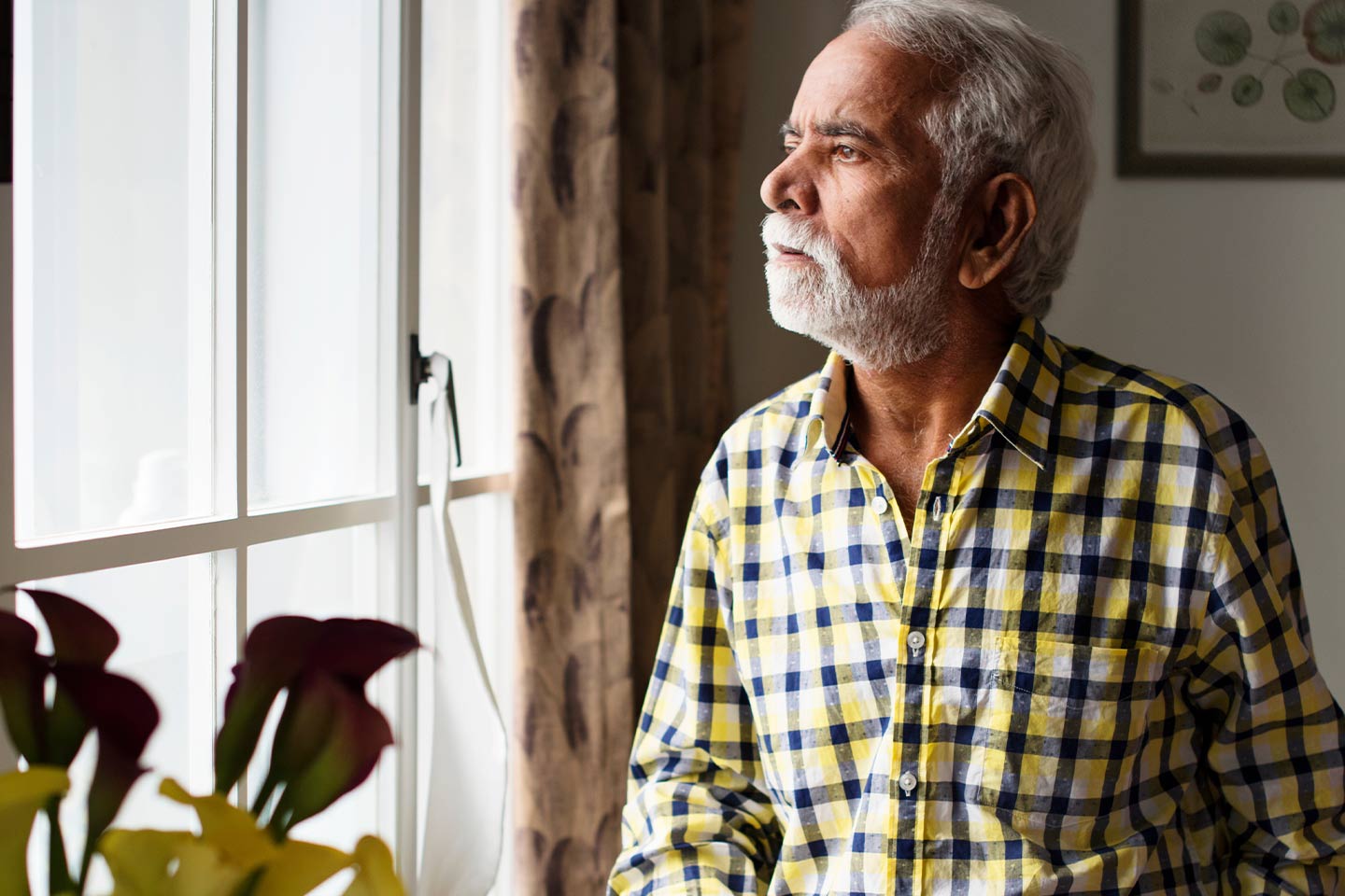 Photo of man in yellow and black plaid shirt
