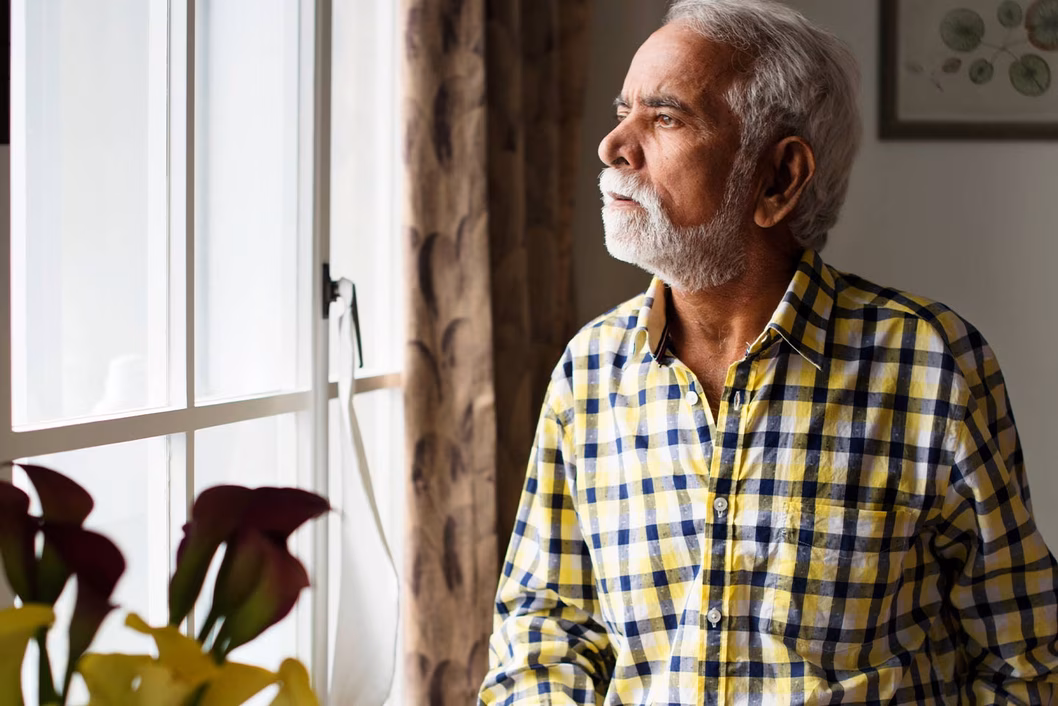 Photo of man in yellow and black plaid shirt