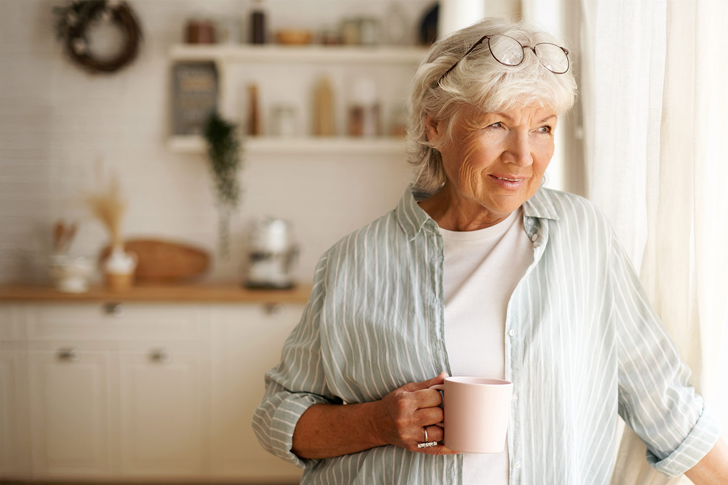Photo of a woman holding a white coffee mug