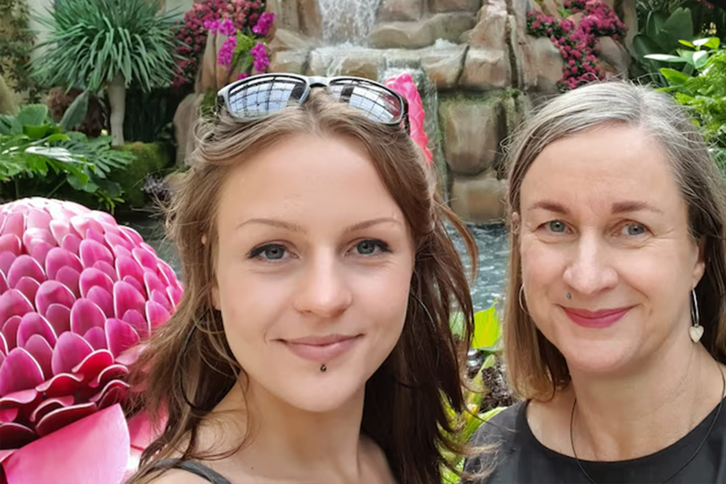 Photo of two smiling women at a water feature