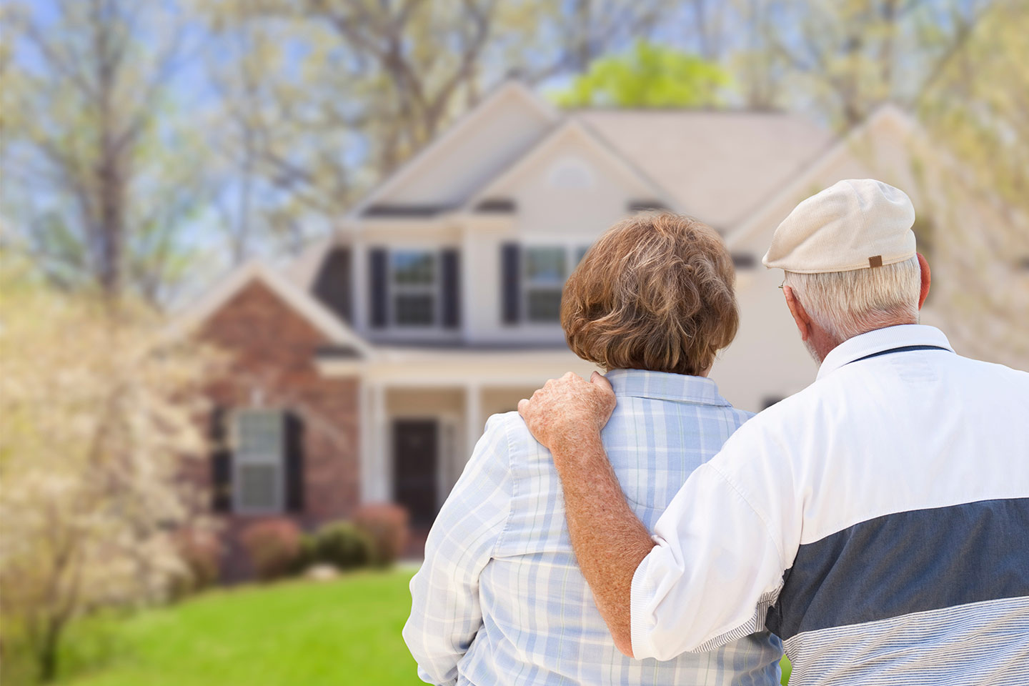 Photo of older couple looking at house