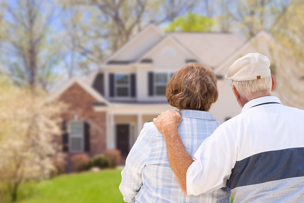 Photo of older couple looking at house