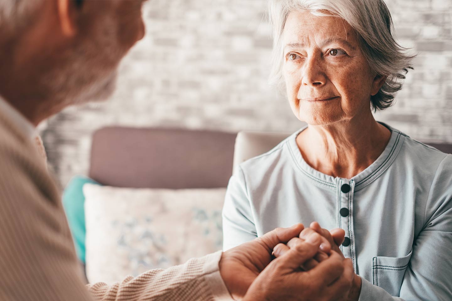 Photo of a woman and a man clasping hands